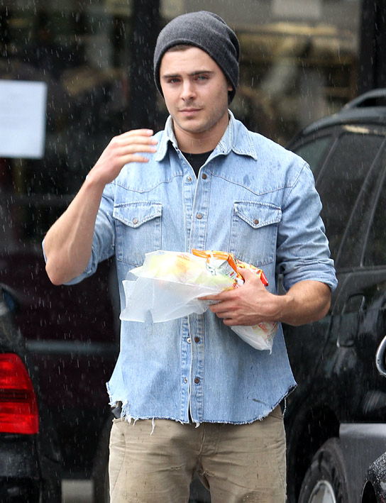 Zac Efron holding a sandwich