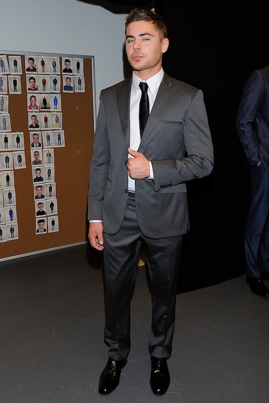 Zac Efron poses at an event