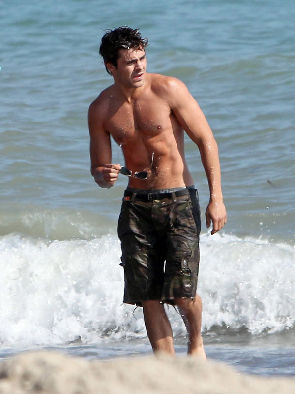 Zac Efron walks shirtless in the water