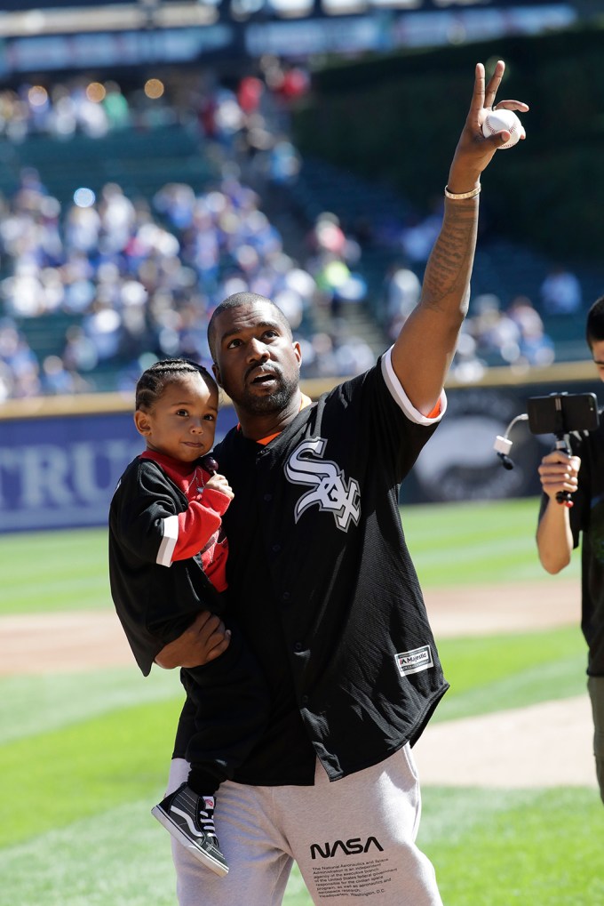 Kanye Holds Saint West At A Chicago White Sox Game