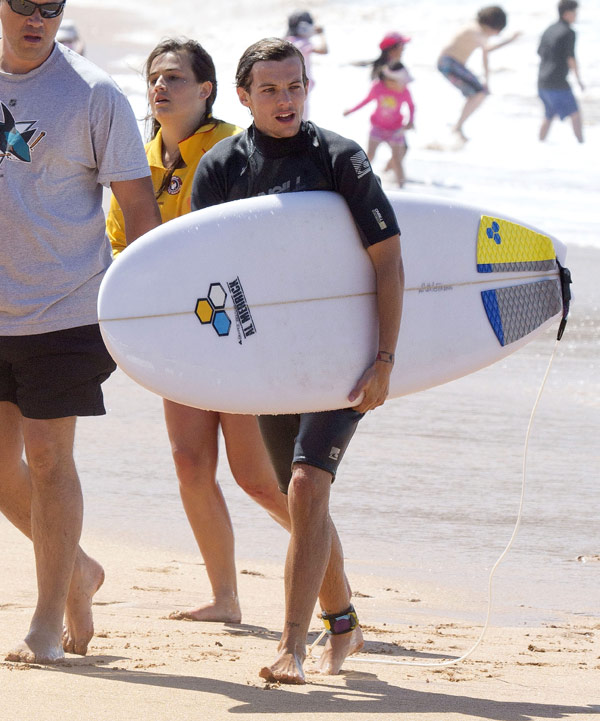 Louis Tomlinson Holding A Surfboard