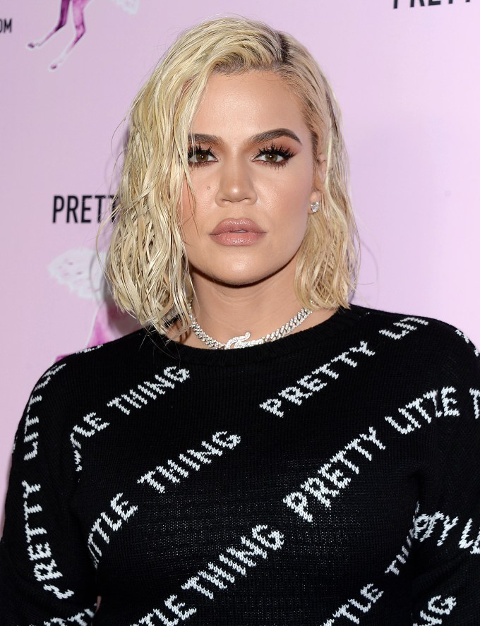 Khloe Kardashian at the PrettyLittleThing office opening party with platinum blonde hair