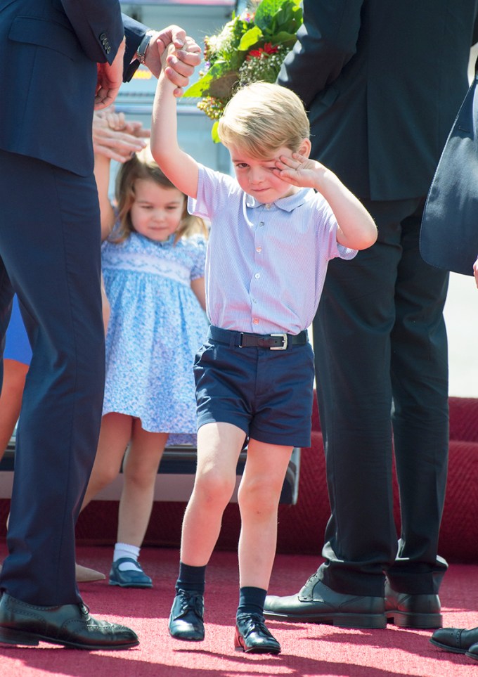 Prince George walking in front of Princess Charlotte