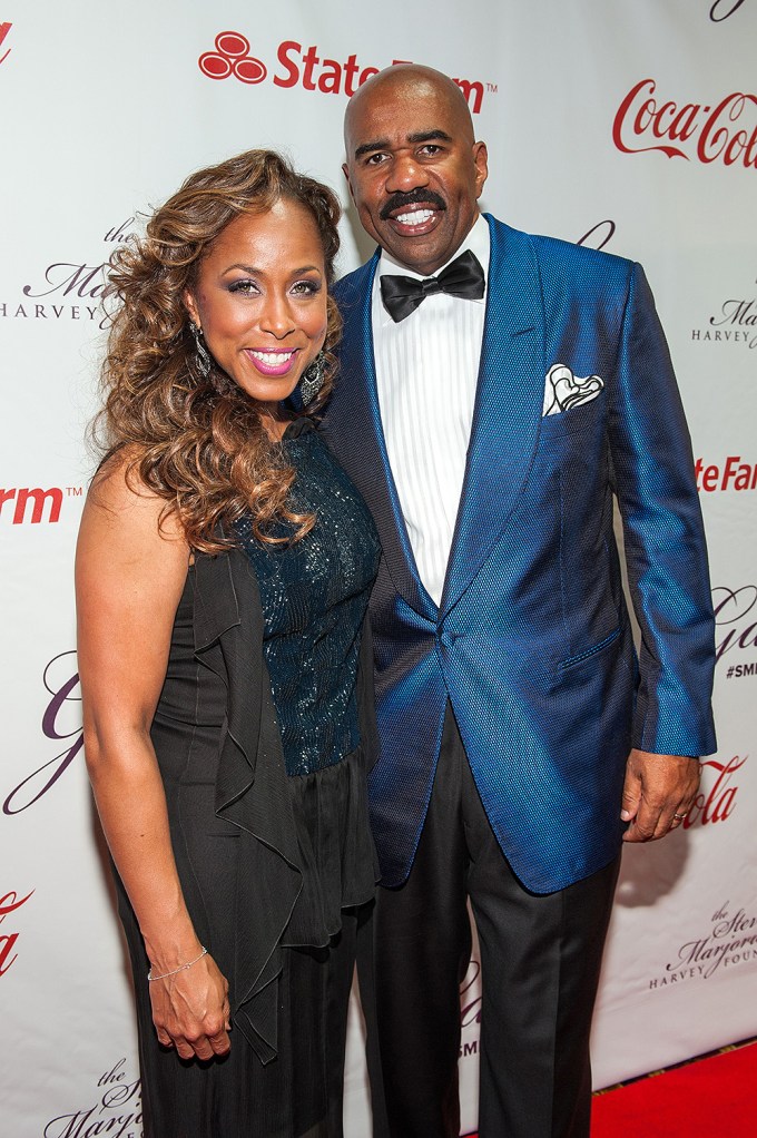 Steve Harvey and his wife on the red carpet