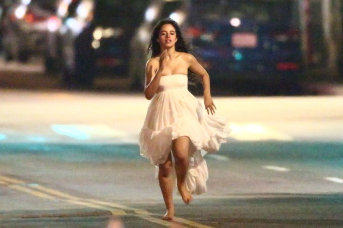 Camila Cabello runs through the streets of L.A. barefoot in a white dress