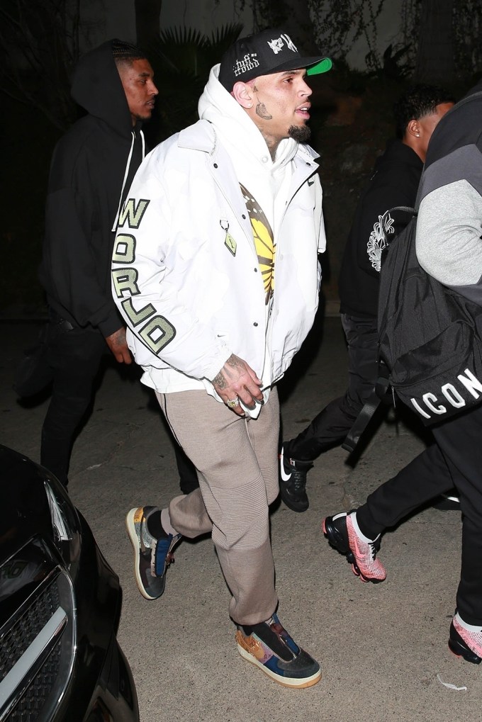 Chris Brown flaunts his new face tat while arriving at a Valentine’s Day Party with Justin Combs