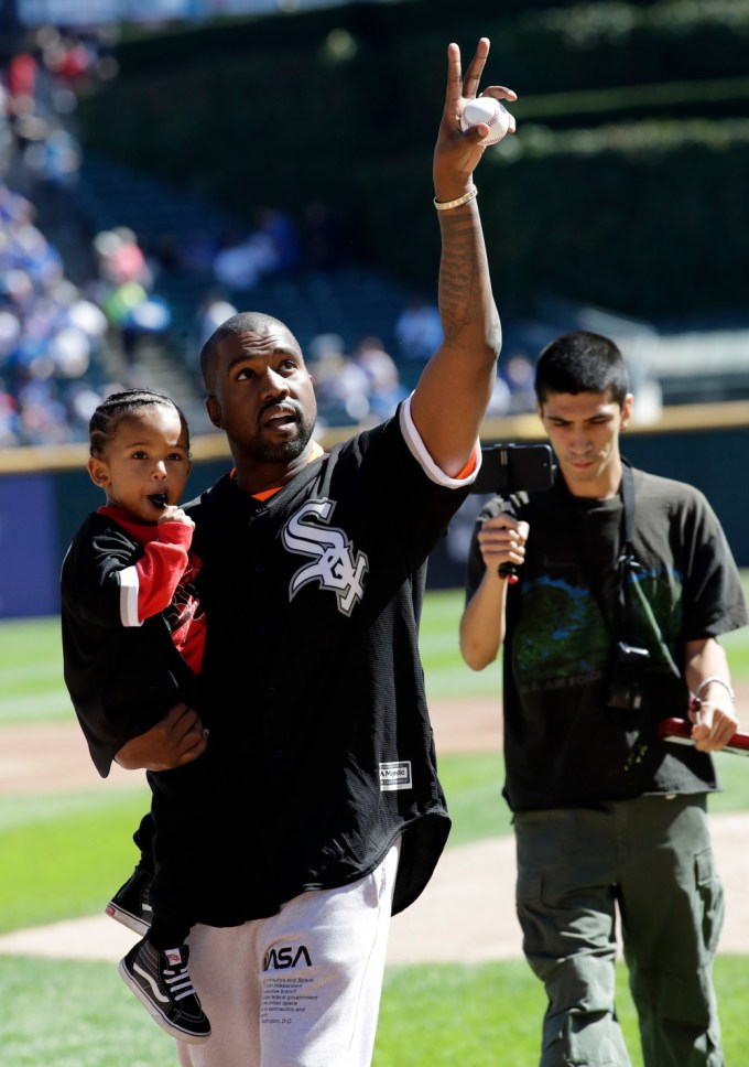 Kanye West and Saint West at a baseball game