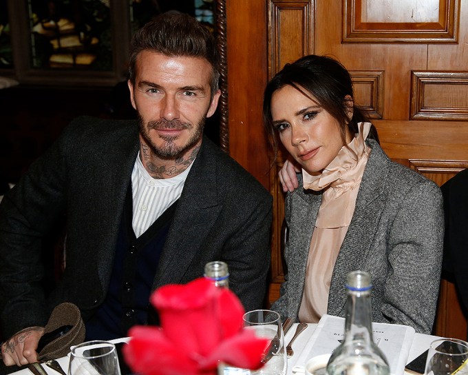 Victoria Beckham and David Beckham at a table