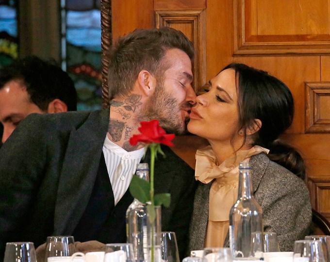 Victoria Beckham and David Beckham kiss