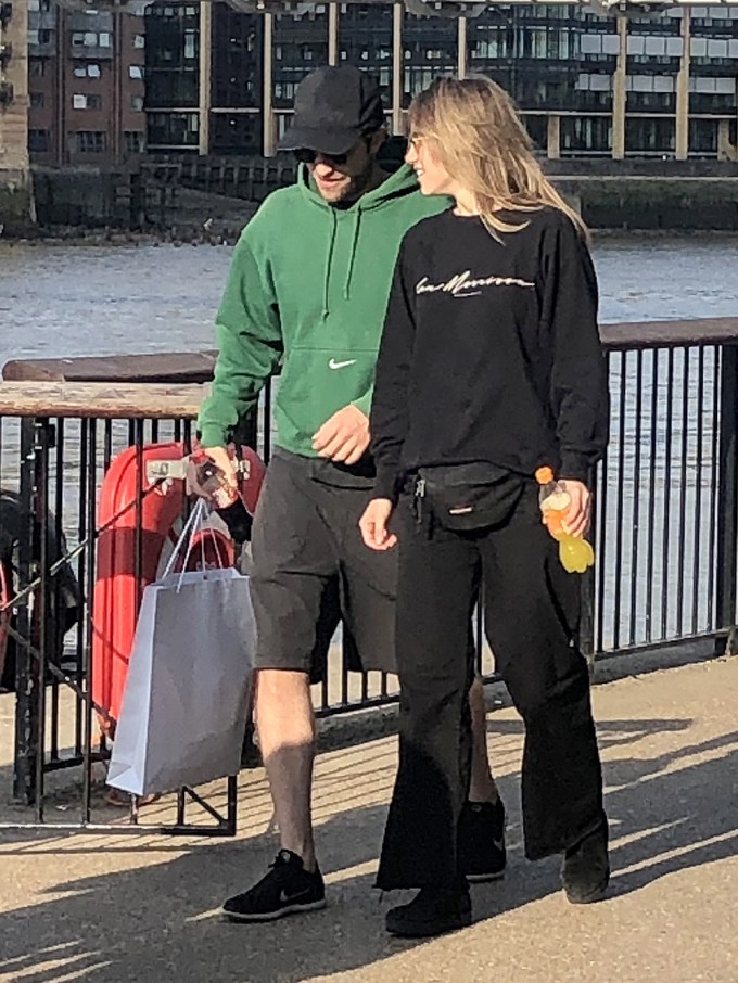 Robert Pattinson & Suki Waterhouse all smiles on a romantic stroll along the Southbank in London