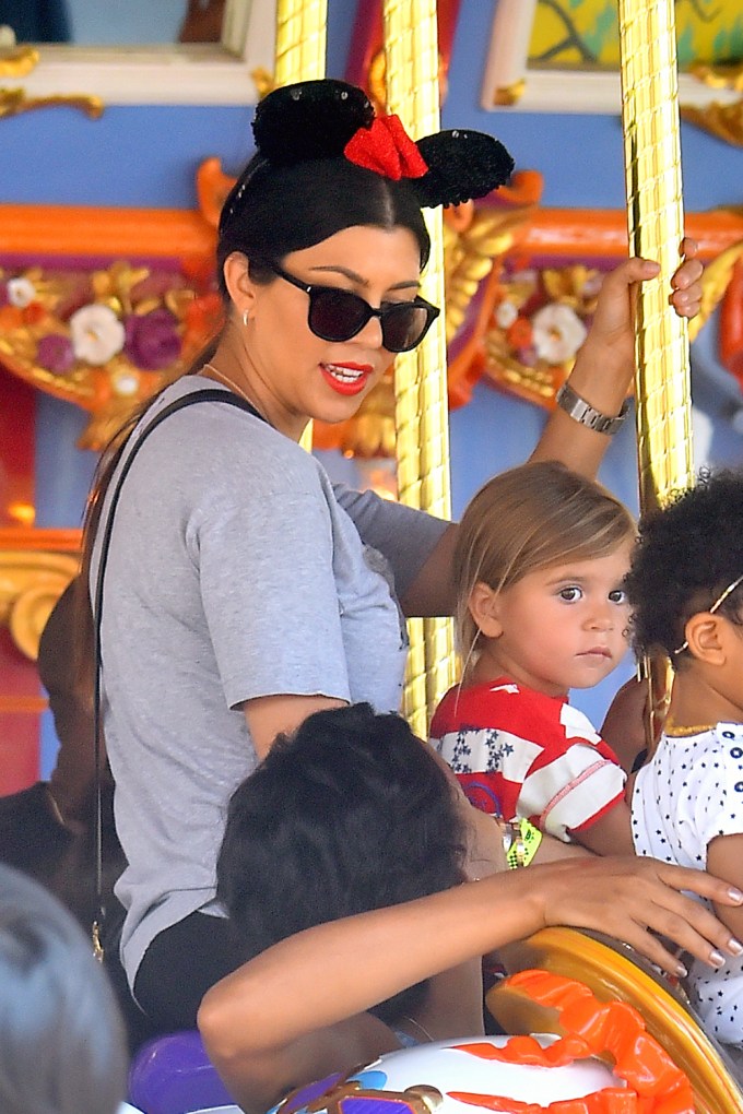 Kourtney And Penelope On A Carousel Ride