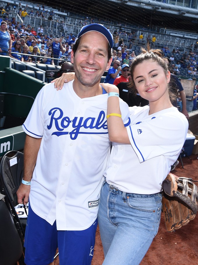 Selena Gomez & Paul Rudd wearing baseball jerseys.