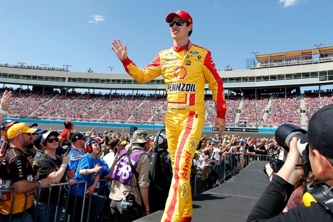 Joey Logano walks out to wave to fans during introductions