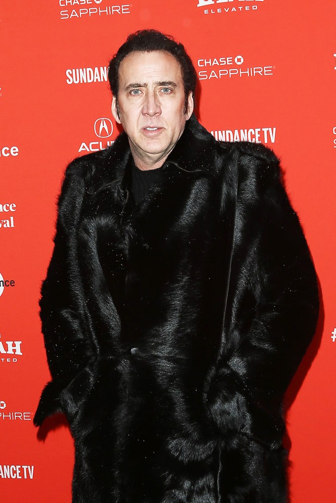 Nicolas Cage wearing a black fur coat