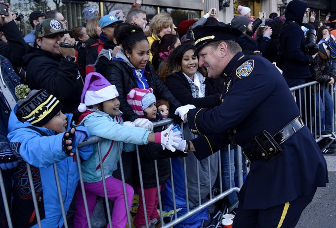 A policeman bonds with spectators at the Macy’s Thanksgiving Day Parade.
