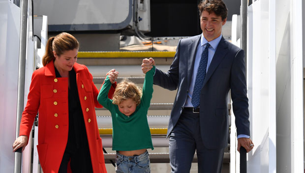 Justin Trudeau holds his son’s hand as the exit an airplane