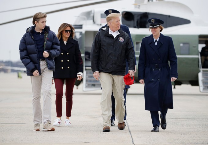 Donald, Melania, and Barron Trump walking outside
