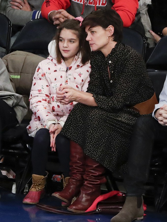 Suri Cruise and Katie Holmes sitting in seats