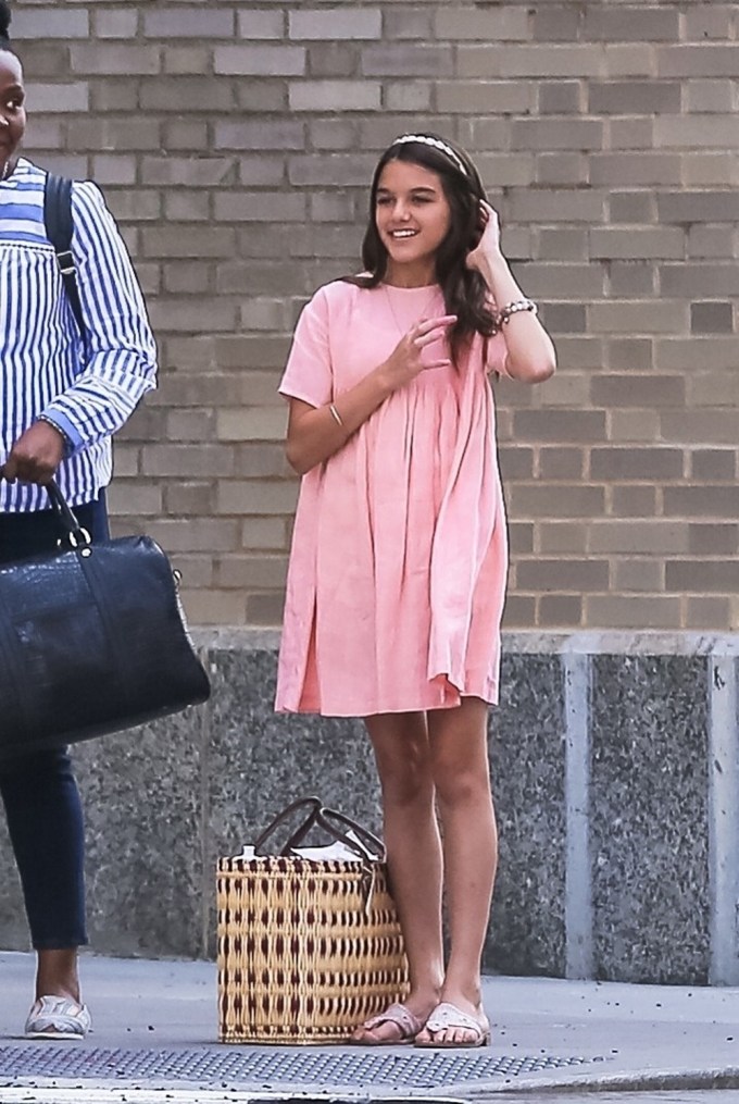 Suri Cruise tries to find a cab with her nanny in NYC
