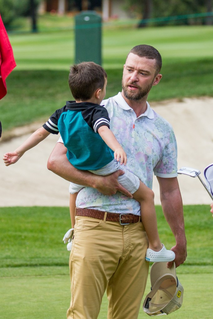 Justin Timberlake carries son Silas on the golf course at the Omega European Masters