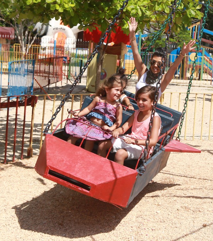Kim Kardashian and Kourtney Kardashian play together at the playground in Cuba with their kids