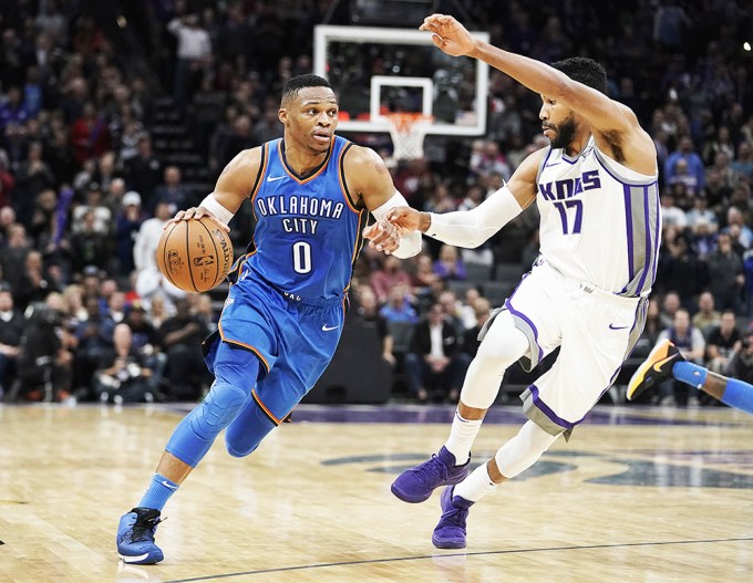 Russell Westbrook Heading For the Basket Against a Kings Defender
