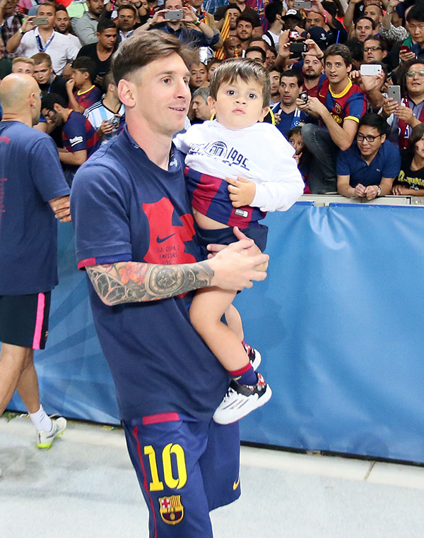 Lionel Messi walks by a crowd