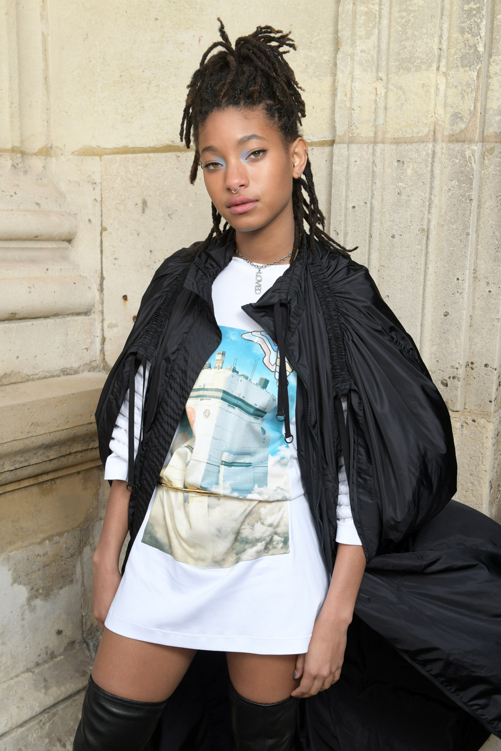 Willow Smith rocks a tiny black crop top with a sleeveless jacket
