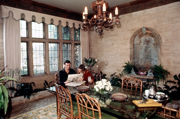 Hugh Hefner Reads The Paper At His Mansion
