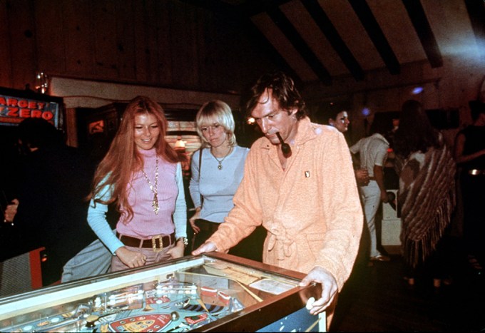 Hugh Hefner Plays Pinball At His Mansion