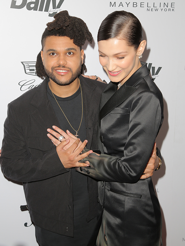 Bella Hadid & The Weeknd pose on a red carpet