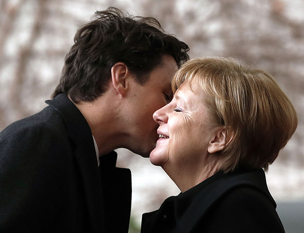Justin Trudeau gives Angela Merkel a kiss on the cheek