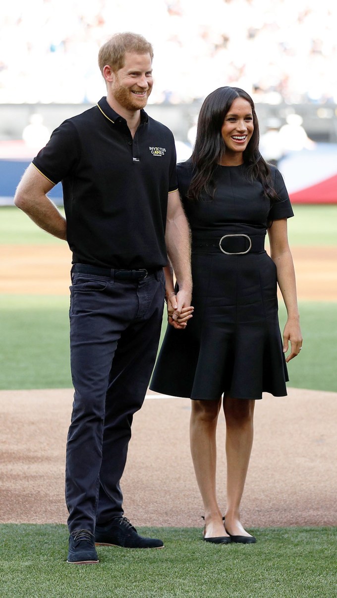 Prince Harry and Meghan Markle hold hands at the Boston Red Sox v New York Yankees baseball match