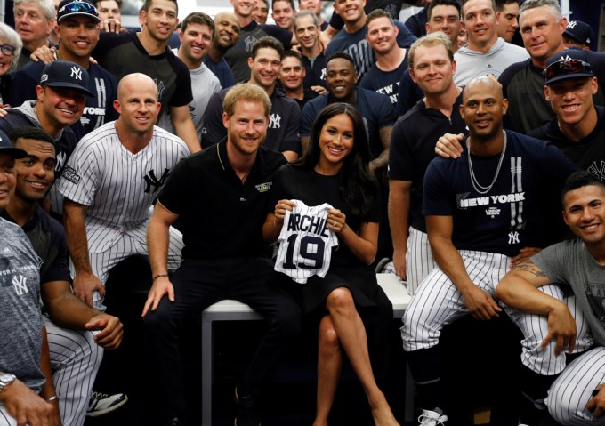 Prince Harry and Meghan Markle pose with the New York Yankees players
