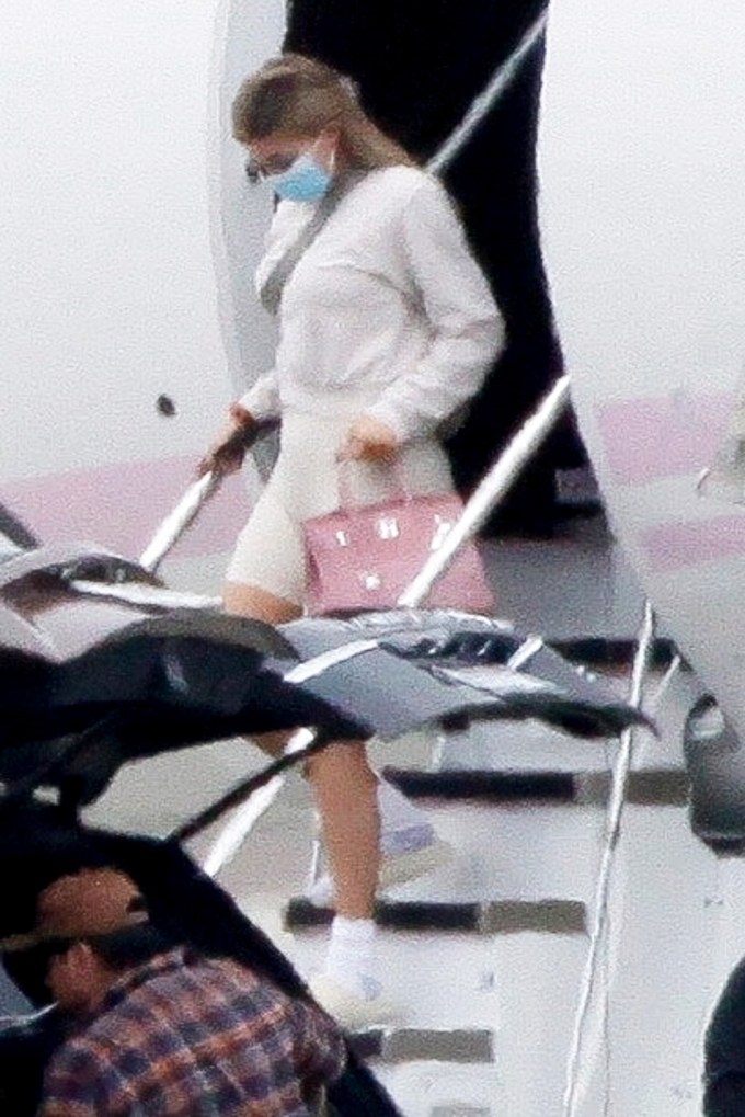 Kylie Jenner Exits Her Pink Private Jet With Travis Scott & Their Daughter Stormi