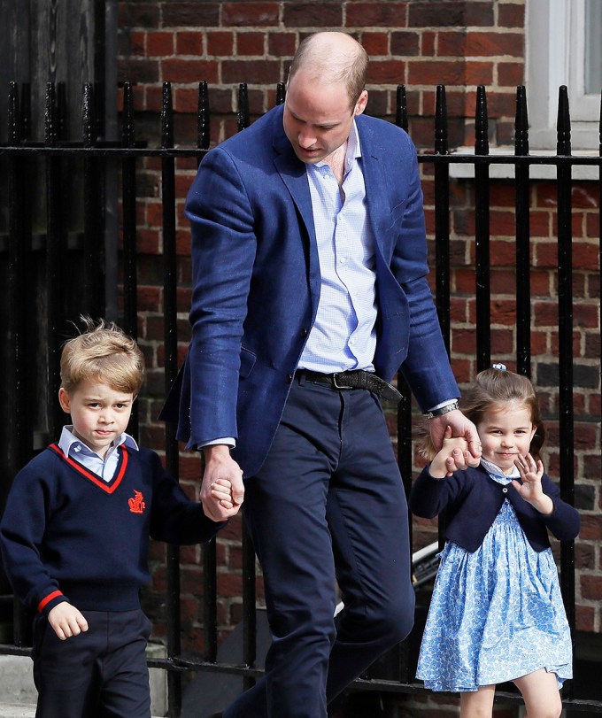 Prince William, Prince George and Princess Charlotte walking to meet Prince Louis