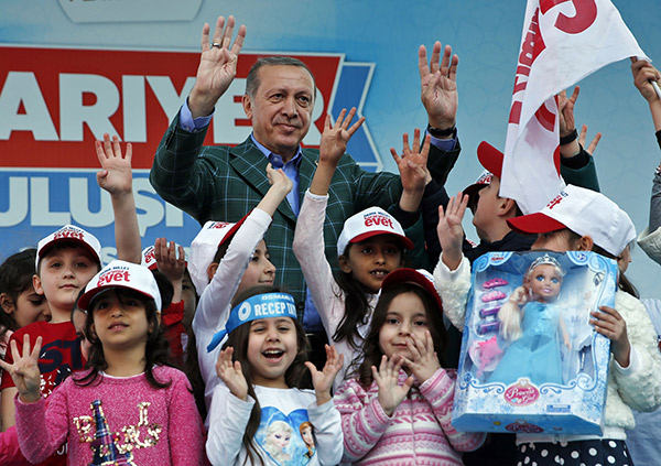 Recep-Tayyip-Erdogan-waves-to-supporters-as-he-poses-with-children-during-his-last-rally-ahead-of-Sunday’s-referendum,-in-Istanbul
