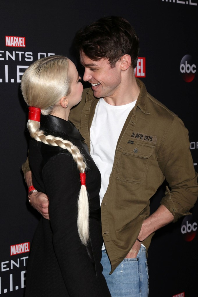 Dove Cameron and Thomas Doherty gazing at one another at the ‘Agents of S.H.I.E.L.D’ 100th Episode Celebration