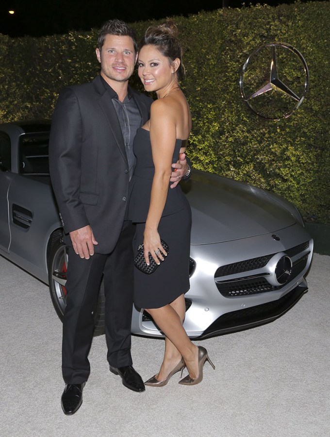 Nick and Vanessa Lachey In Front Of A BMW