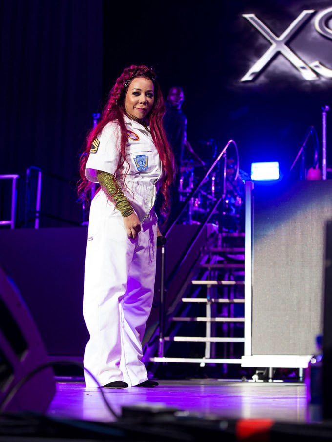 Tiny Harris onstage performing with Xscape.