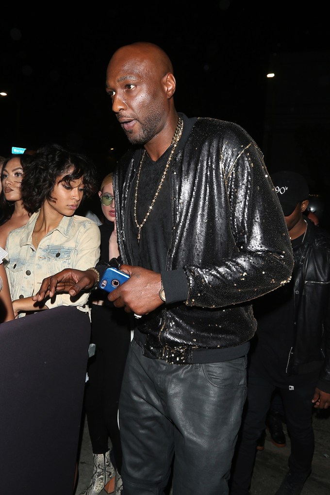 Lamar Odom is color coordinated with his shimmering black jacket and jeans as he arrives at the Poppy club to celebrate rapper Drake’s 31st birthday party