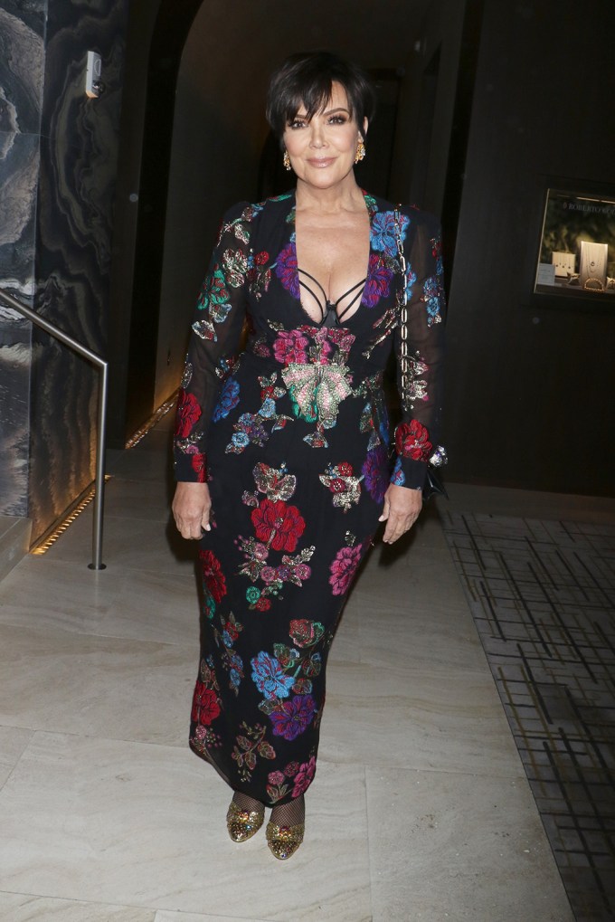 Kris Jenner wears a plunging Gucci gown.