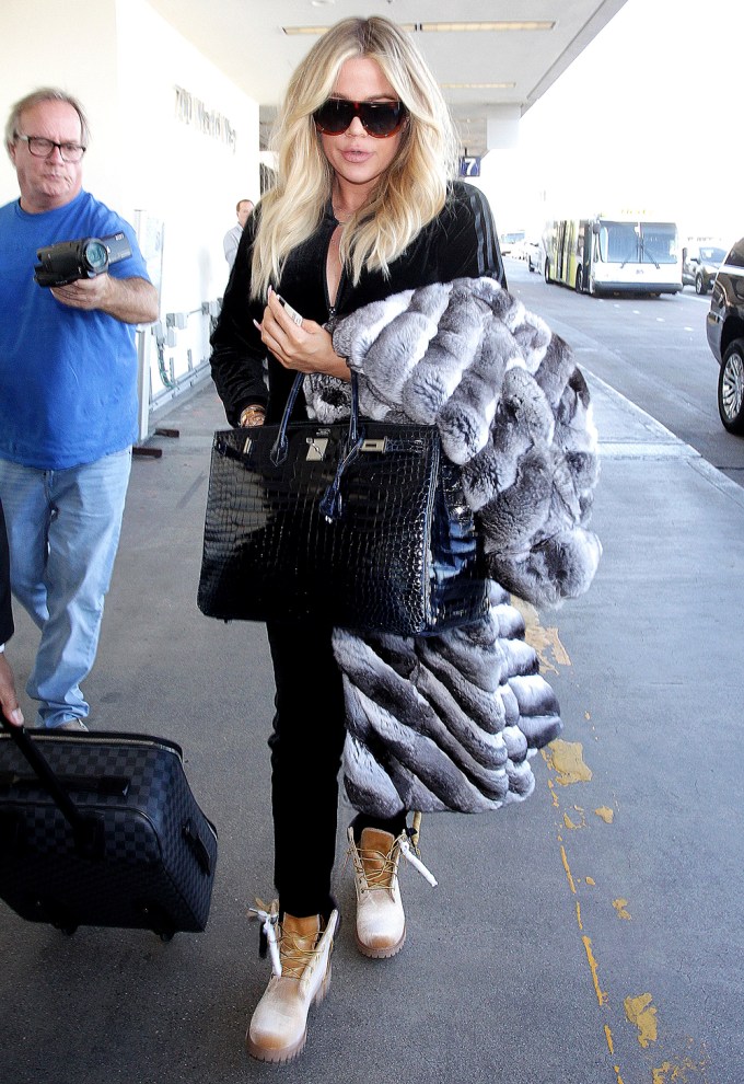 Khloe Kardashian covers her baby bump with a fur coat as she jets to Cleveland to spend New Year’s Eve with beau Tristan Thompson