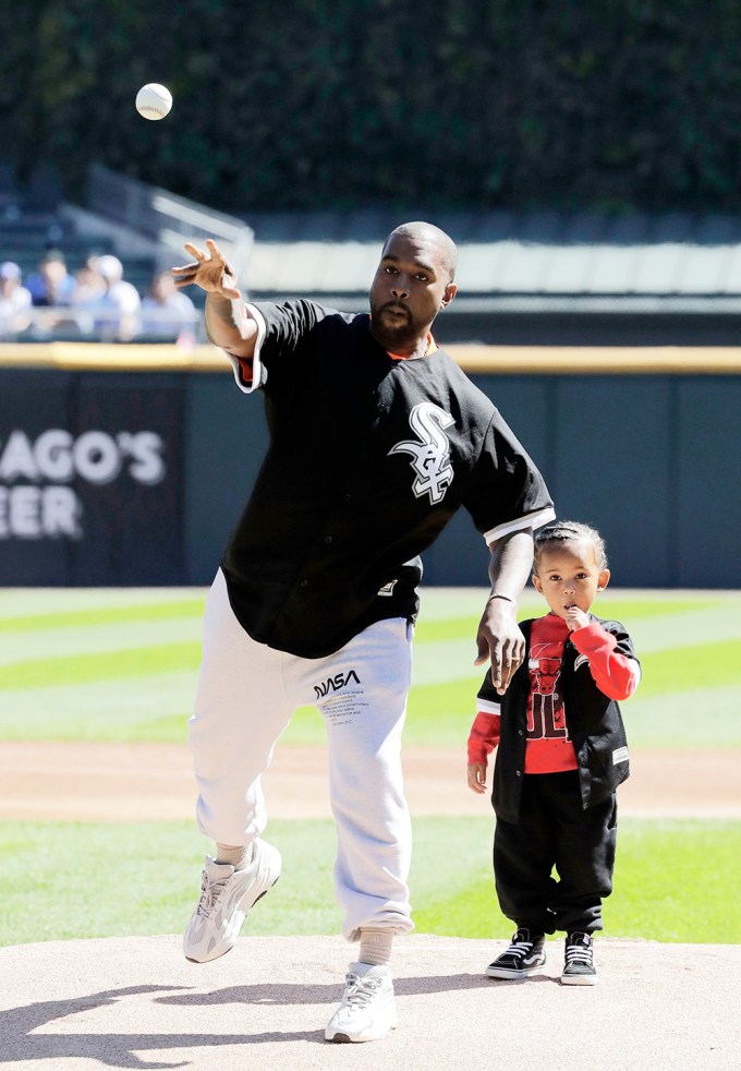 Kanye West & Saint West in a baseball field
