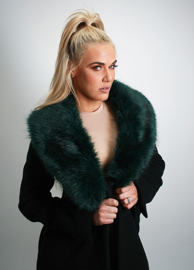 Lana shows off her forest green fur trench