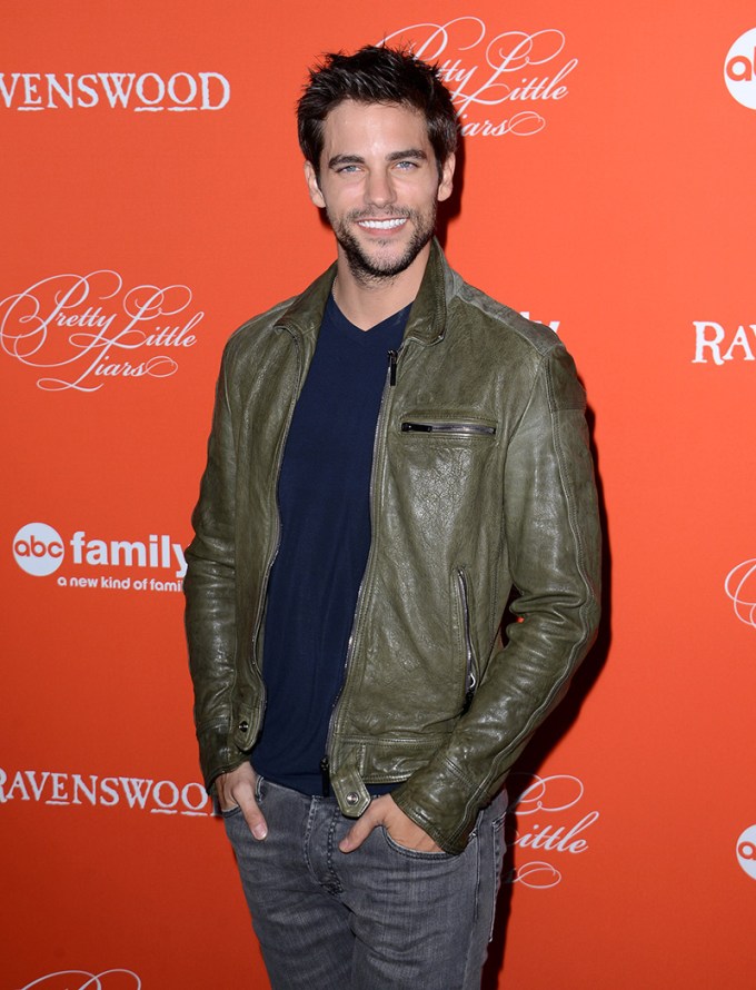 Brant Daugherty smiles on a red carpet