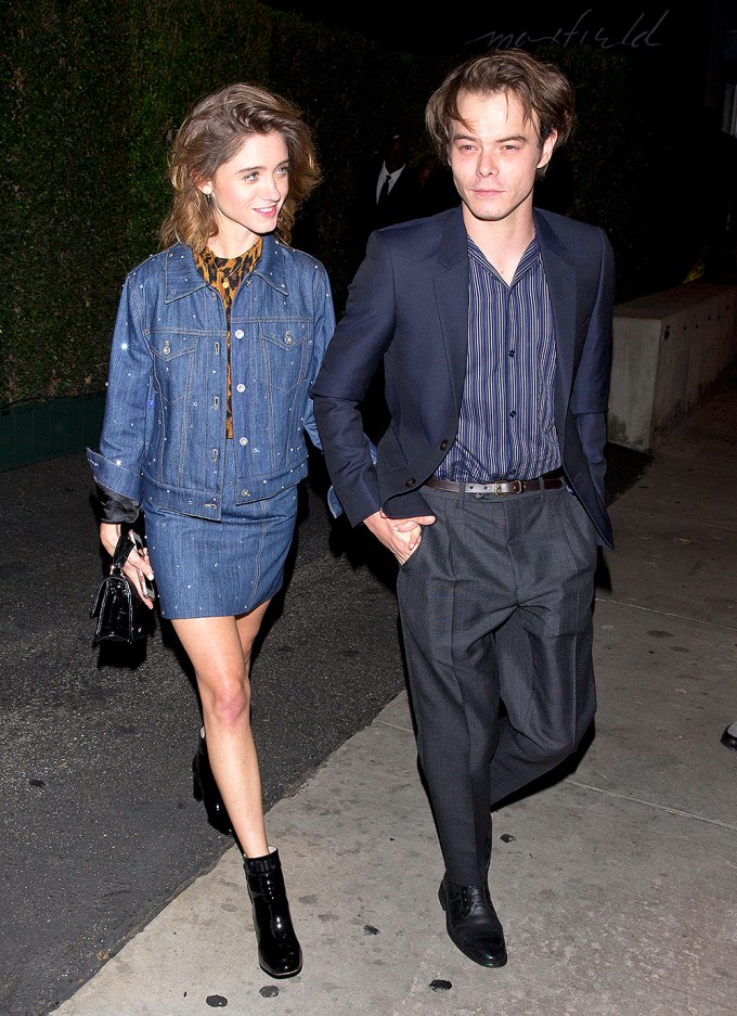 Natalia Dyer and Charlie Heaton hold hands