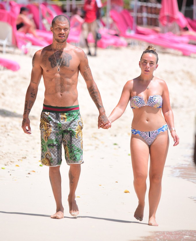 Jeremy Meeks & Chloe Green hold hands on a beach
