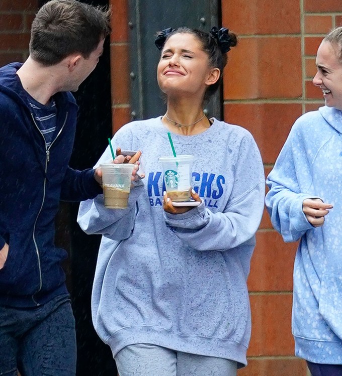 Ariana Grande takes a break from thinking about ex Mac Miller as she walks in the rain with her friends and go to the park to enjoy coffee in New York