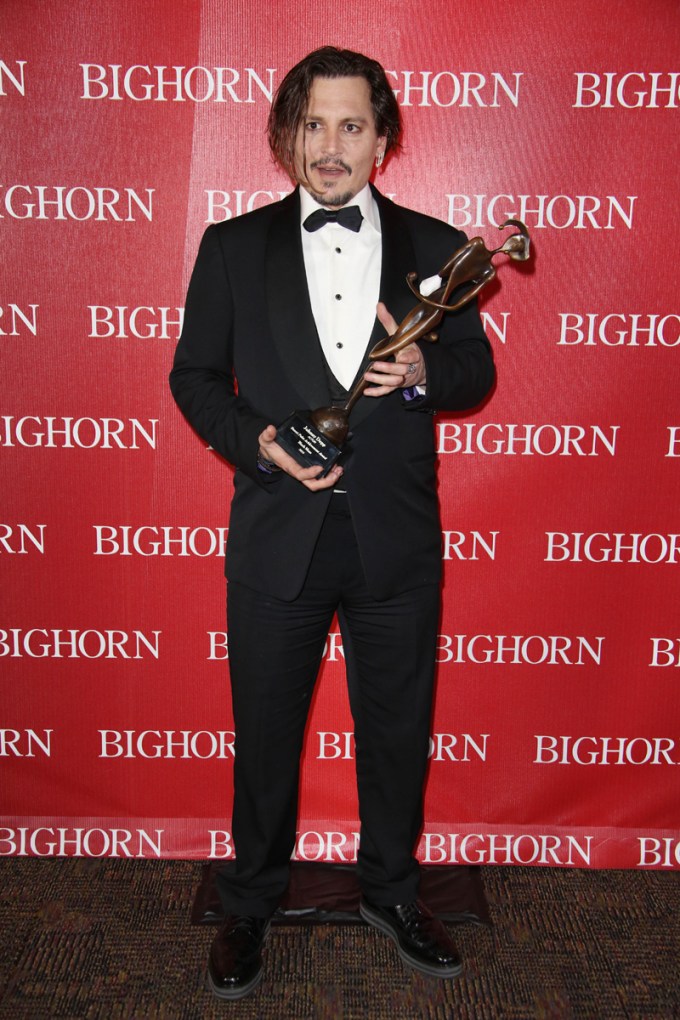 Johnny Depp holds an award